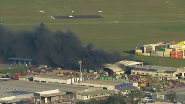 Firefighters battling larger commercial structure fire in Rocklea in Queensland. 