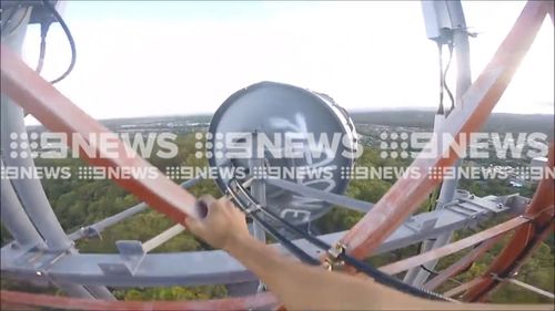 The teens scaling the 34m tall structure at Parkwood without any safety equipment. (9NEWS)