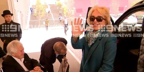 Ms d'Alpuget was all smiles as she left the Langham with her husband. (9NEWS)