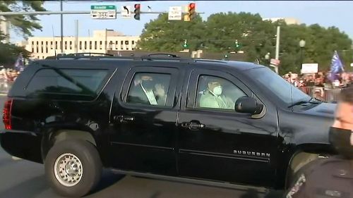Donald Trump waves to supporters outside the Walter Reed National Military Medical Center.