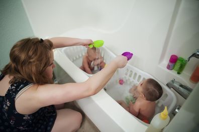 Woman bathing children