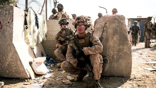 US Marines take a moment to rest during an evacuation at Hamid Karzai International Airport in Kabul, Afghanistan.
