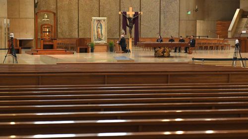 Archbishop of Los Angeles Jose H Gomez prays the rosary in front of an empty cathedral.