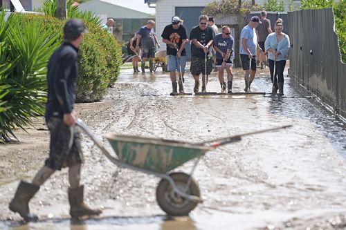 Residents in Taradale, New Zealand clean up silt following Cyclone Gabrielle