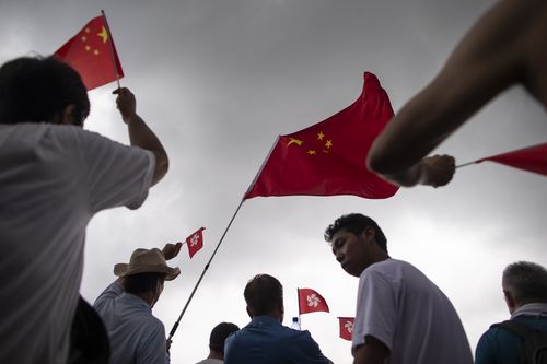 Chinese national flags being waved by pro police demonstrators during the rally in support of the police. 