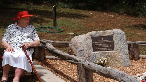 Lady Bjelke-Petersen sits at the grave of Sir Joh Bjelke-Petersen on the family property Bethany at Kingaroy, north west of Brisbane in 2006. (Image: AAP)