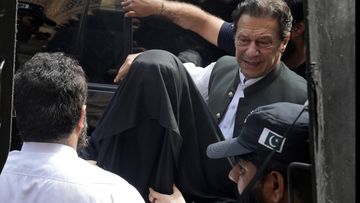Pakistan&#x27;s former Prime Minister Imran Khan, right, with his wife Bushra Bibi, centre, arrive to appear in a court in Lahore, Pakistan, on June 26, 2023.  