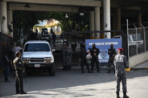 Gaurds pictured outside Helicoide prison during the riot.Picture: Roman Camacho/SOPA Images/LightRocket via Getty Images