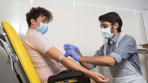 A doctor takes blood samples for use in a coronavirus vaccine trial in Oxford.