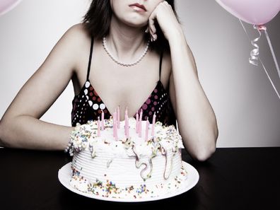 Sad woman birthday cake photo