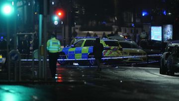 Police attend the scene near Kensington High Street, where British police say a man has been shot dead during a confrontation with officers. (Aaron Chown/PA via AP)