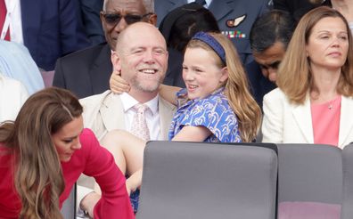 Mia Tindall gives dad Mike Tindall a hug as they watch the Platinum Jubilee Pageant outside Buckingham Palace in London, Sunday June 5, 2022.