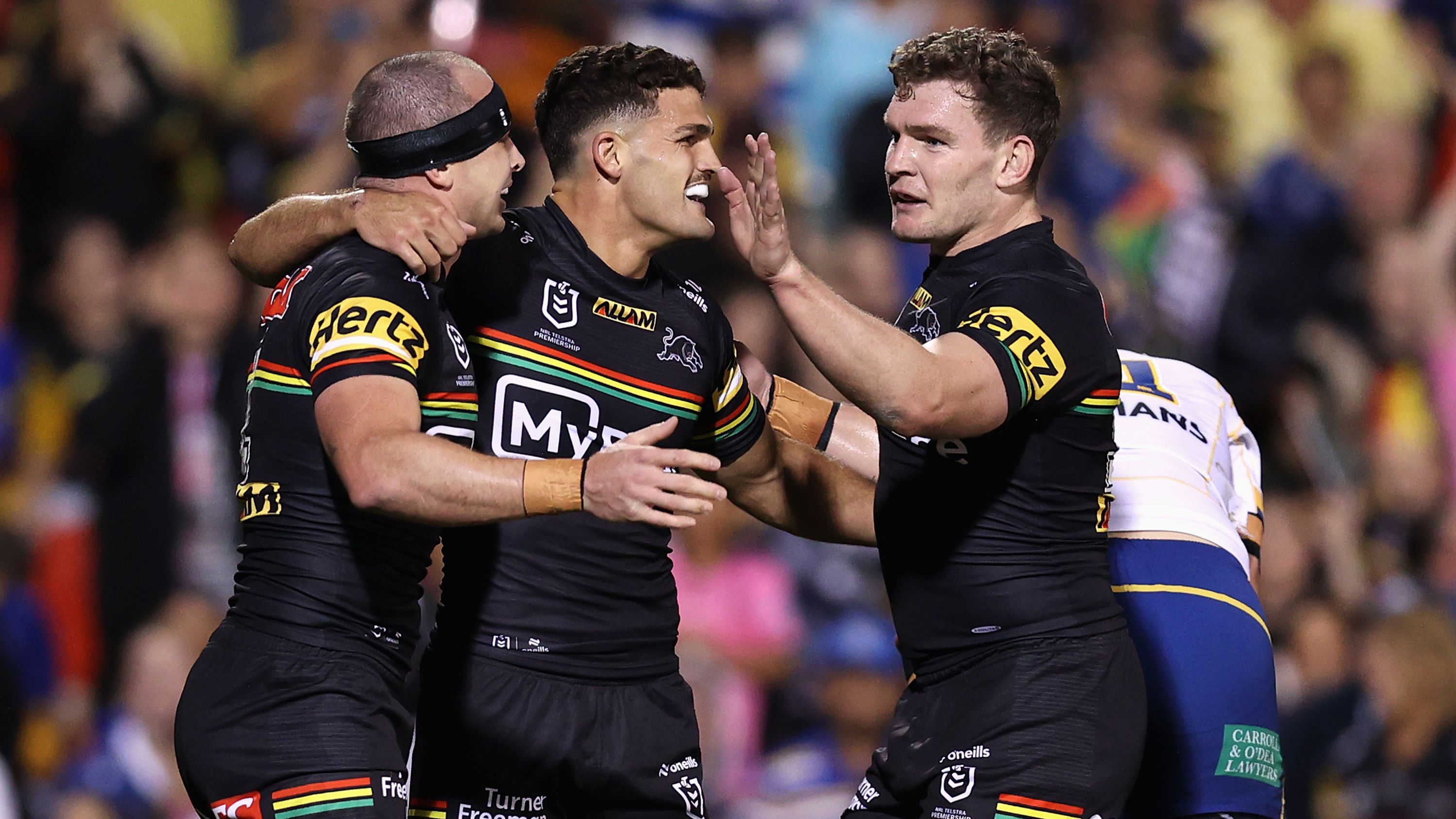 Dylan Edwards of the Panthers celebrates scoring a try with Nathan Cleary and Liam Martin of the Panthers during the round two NRL match between Penrith Panthers and Parramatta Eels at BlueBet Stadium, on March 15, 2024, in Penrith, Australia. (Photo by Jason McCawley/Getty Images)