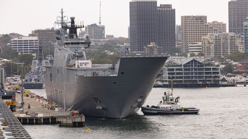 HMAS Adelaide prepares to depart Garden Island fleet base in Sydney.