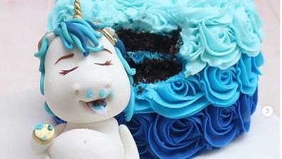 Unicorn sleeps on cake