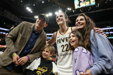 LOS ANGELES, CALIFORNIA - MAY 24: Caitlin Clark #22 of the Indiana Fever poses for a photo with Ashton Kutcher and Mila Kunis after defeating the Los Angeles Sparks at Crypto.com Arena on May 24, 2024 in Los Angeles, California. NOTE TO USER: User expressly acknowledges and agrees that, by downloading and or using this photograph, User is consenting to the terms and conditions of the Getty Images License Agreement. (Photo by Harry How/Getty Images)