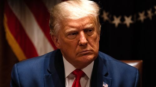 US President Donald Trump listens during a meeting in the Cabinet Room of the White House