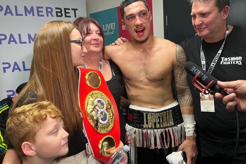 Jai Opetaia shows off his busted jaw with his mother after winning the IBF cruiserweight world title.