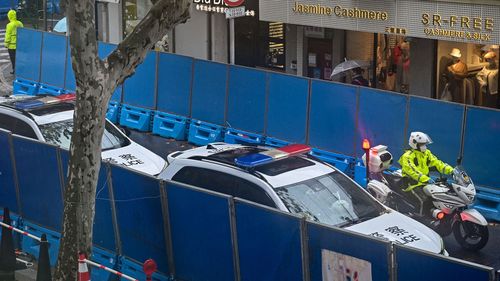 Police cars patrol Shanghai's Urumqi Road