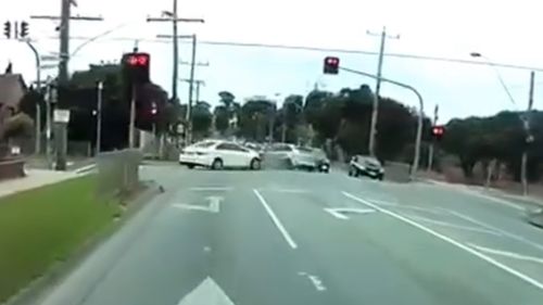 The Focus then smashes into a vehicle waiting to turn right at the red lights. (YouTube)