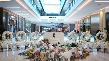 Floral tributes are seen at a memorial site during the re-opening of the Westfield Bondi Junction shopping centre on April 19, 2024 in Sydney, Australia