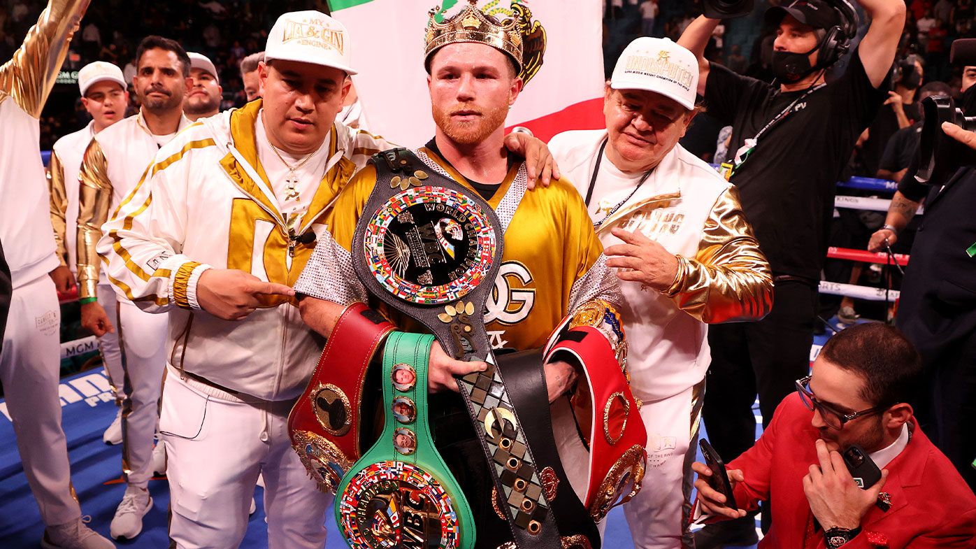 Canelo Alvarez poses with the belts after his championship bout for Alvarez&#x27;s WBC, WBO and WBA super middleweight titles and Plant&#x27;s IBF super middleweight title