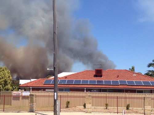 Black smoke can be seen in Perth's outer suburbs. (9NEWS)