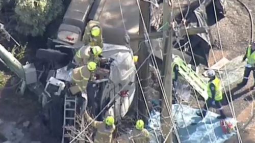 Firefighters worked for over an hour to free the driver. (9NEWS)