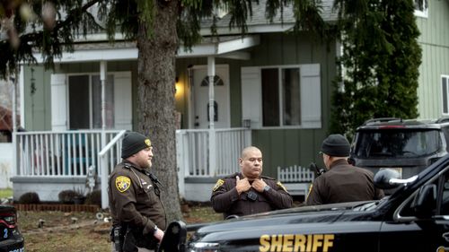 Oakland County Sheriff's Deputies survey the grounds outside of the Crumbley residence. 