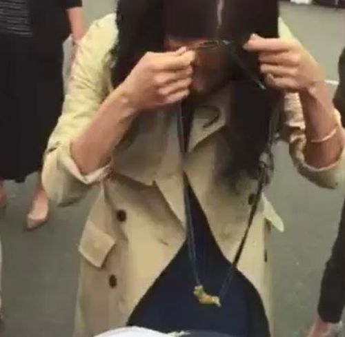 To his surprise, Meghan put on the necklace as she greeted royal fans. 
