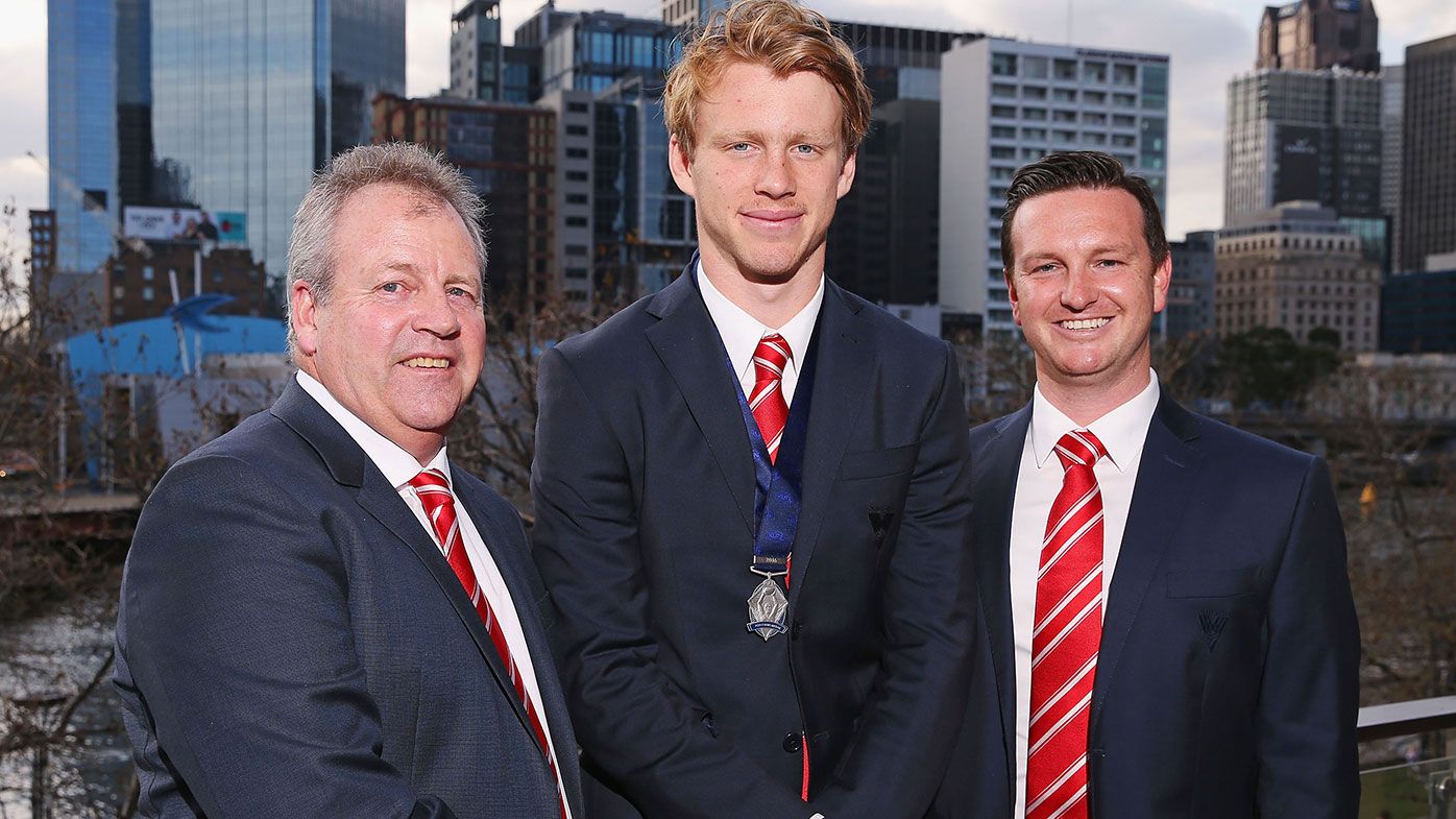 Swans recruiting managers Kinnear Beatson (L) and Michael Agresta pose with Rising Star winner Callum Mills of the Swans during the 2016 AFL Rising Star Announcement