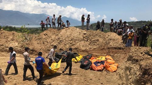 Bodies are being buried in mass graves after the Indonesian earthquake and tsunami.