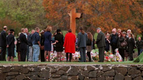 Families and friends gather around the memorial at Port Arthur a year after the tragedy in 1997.