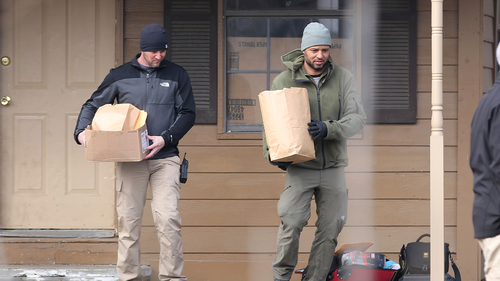 Investigators remove items from the scene of a suspected mass homicide where at least five children were slain Tuesday, Feb. 2, 2021 in Muskogee, Oklahoma.