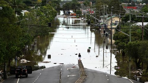 A main street is under floodwater in Lismore.