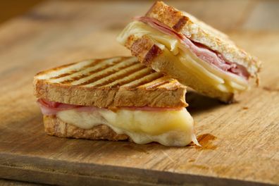 Hot off the grill panini sandwiches made with crusty, hand sliced bread, black forest ham and swiss cheese.