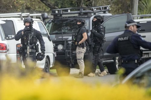 Police surround the Alexandra Headland unit during the siege. Picture: AAP