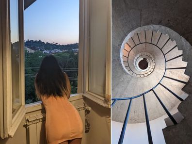 A woman leans stars out of a window overlooking the hills of Florence.
