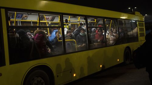 Displaced Ukrainians take a bus ride to Poland from Lviv train station in western Ukraine on Saturday, March 5, 2022. Russian troops took control of the southern port city of Kherson this week. Although they have encircled Kharkiv, Mykolaiv, Chernihiv and Sumy, Ukrainian forces have managed to keep control of key cities in central and southeastern Ukraine, Ukrainian President Volodymyr Zelenskyy said Saturday. (AP Photo/Bernat Armangue)