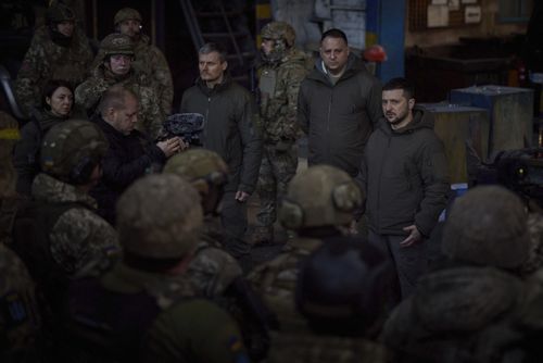 Ukrainian President Volodymyr Zelenskyy, right, speaks to soldiers at the site of the heaviest battles with the Russian invaders, in Bakhmut, Ukraine, Tuesday, Dec. 20, 2022.