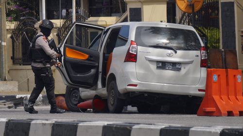 Prosecutors say the Islamic cleric directed his followers to conduct the attacks, including this incident where sword-wielding men drove into police headquarters in Sumatra this week. Picture: AAP.