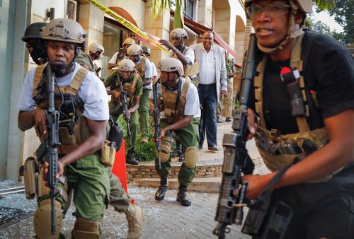 Kenyan security officers search for attackers during the attack on an upmarket hotel in Nairobi.