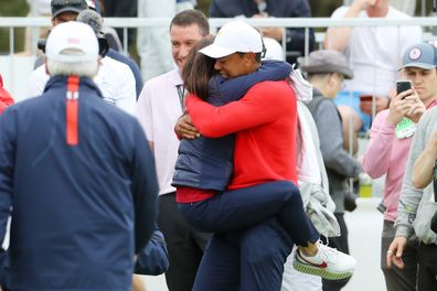 MELBOURNE, AUSTRALIA - DECEMBER 15:  Playing Captain Tiger Woods of the United States team celebrates with girlfriend Erica Herman after defeating Abraham Ancer of Mexico and the International team 3&2 during Sunday Singles matches on day four of the 2019 Presidents Cup at Royal Melbourne Golf Course on December 15, 2019 in Melbourne, Australia. (Photo by Warren Little/Getty Images)
