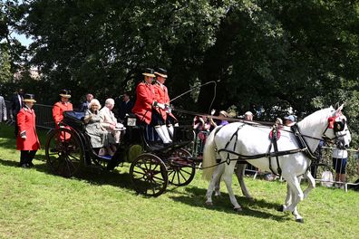 Queen Camilla and King Charles III depart by carriage after their visit to Sandringham Flower Show at Sandringham House on July 26, 2023 in King's Lynn, England. 