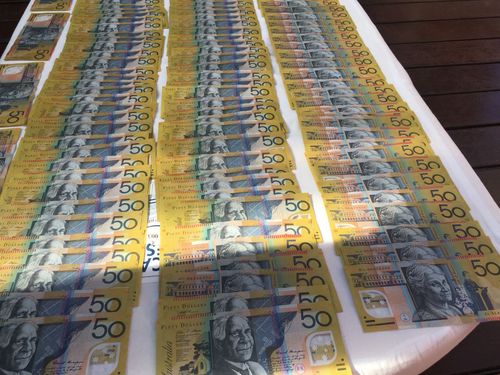 Officers seized about $10,000 in cash from one of the properties. Picture: NSW Police