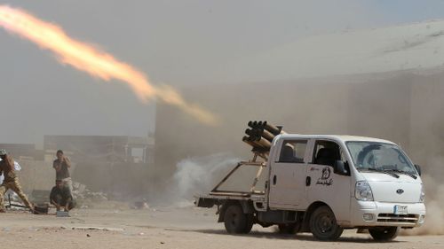 Iraqi Shiite militia fighters fire a rocket at Islamic State militant positions at Sayed Hassan village, Iraq. (Getty Images)
