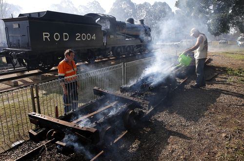 Richmond Vale Railway Museum volunteers Graeme Glanville and Peter Gunnell work to save the museum's rare vintage coal mine underground skips. (AAP)