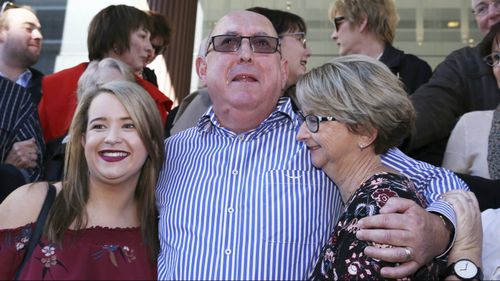 Mr Creigh embraces family members outside Newcastle Local Court. (AAP)