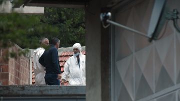 Police investigators on the site of the attack in Cetinje, 36 kilometres west of Podogrica, Montenegro, Friday, Aug. 12, 2022. A man in Montenegro went on a shooting rampage after a family dispute, killing 11 people on the streets of a city before being shot dead in a gun battle with police. (AP Photo/Risto Bozovic)