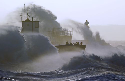 Waves crash against the sea wall and Porthcawl Lighthouse in Porthcawl, Bridgend, Wales, as Storm Eunice hits the south coast, with attractions closing, travel disruption and a major incident declared in some areas, meaning people are warned to stay indoors. Picture date: Friday February 18, 2022.  